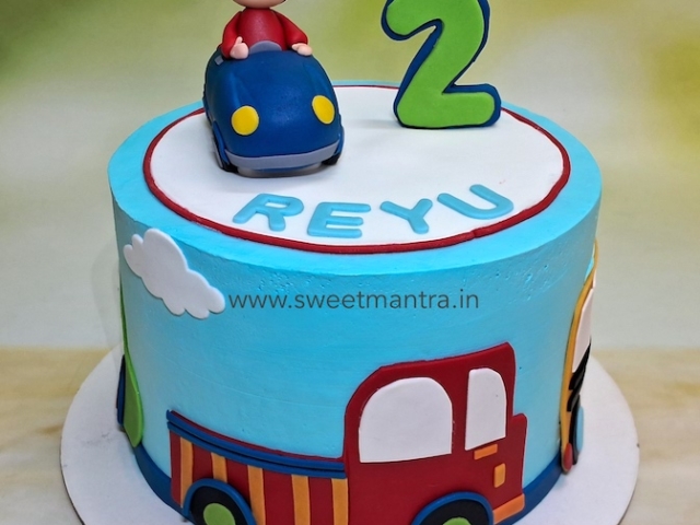 Vehicles theme cake in whipped cream
